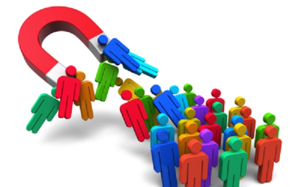 Social engineering concept: horseshoe magnet capturing crowd of color human figures isolated on white background